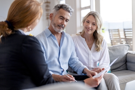 happy couple talking with a lawyer
