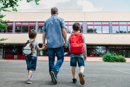 father walking children to school