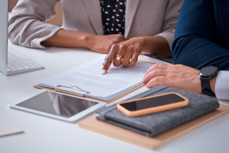 two people reviewing legal documents