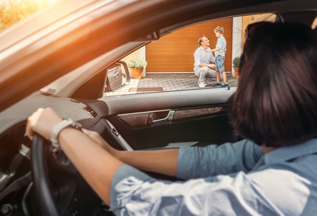 Mom waiting for son inside of car.